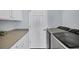 Clean laundry room featuring modern washer and dryer, storage cabinets, and a folding countertop at 13113 Gasparilla Rd # A503, Placida, FL 33946