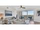 Bright living room with water views, neutral furniture, and access to a private balcony at 13113 Gasparilla Rd # A503, Placida, FL 33946