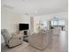 Inviting living room with a TV, comfortable furniture, and access to a scenic balcony at 13113 Gasparilla Rd # A503, Placida, FL 33946