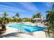 Resort-style pool with palm trees, lounge chairs, and a gazebo for relaxation at 13113 Gasparilla Rd # A503, Placida, FL 33946