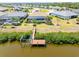 Waterfront home features a private dock, boat lift and screened-in pool, creating a serene oasis at 14556 Gaspar Loop, Port Charlotte, FL 33981