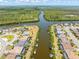 Beautiful aerial view features waterfront homes with private docks, surrounded by lush greenery and waterway at 14556 Gaspar Loop, Port Charlotte, FL 33981