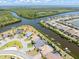 Aerial view showcases waterfront homes with private docks and boat lifts, complemented by beautiful landscaping at 14556 Gaspar Loop, Port Charlotte, FL 33981