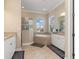 Bright bathroom with a soaking tub, double vanities, and natural light at 14556 Gaspar Loop, Port Charlotte, FL 33981