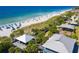 Coastal view of a white sand beach with clear blue water, beachgoers, and nearby park amenities at 14556 Gaspar Loop, Port Charlotte, FL 33981