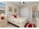 Bedroom featuring a ceiling fan, a queen-size bed with seashell bedspread, and tile flooring at 14556 Gaspar Loop, Port Charlotte, FL 33981