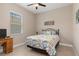 Bedroom featuring tile flooring, a ceiling fan, and a floral patterned bedspread at 14556 Gaspar Loop, Port Charlotte, FL 33981