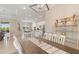 Open-concept dining area with views of the kitchen and living area, complemented by a modern light fixture at 14556 Gaspar Loop, Port Charlotte, FL 33981