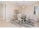 Cozy dining room with neutral walls, window with blinds, and a modern chandelier at 14556 Gaspar Loop, Port Charlotte, FL 33981
