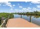 The wooden dock extends to the calm canal, promising serene waterfront living and boating at 14556 Gaspar Loop, Port Charlotte, FL 33981