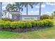 Welcoming entrance sign for Harbor West, surrounded by greenery and manicured landscaping at 14556 Gaspar Loop, Port Charlotte, FL 33981