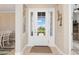 Bright entryway features a glass-paneled front door flanked by sidelights, showcasing exterior views at 14556 Gaspar Loop, Port Charlotte, FL 33981