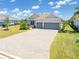 Well maintained home featuring tile roof, paver driveway and lush landscaping at 14556 Gaspar Loop, Port Charlotte, FL 33981