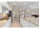 Open kitchen with stainless steel appliances, granite countertops, and seamless access to other rooms at 14556 Gaspar Loop, Port Charlotte, FL 33981