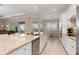 Bright kitchen with granite countertops, stainless steel appliances, and a view to the outdoor patio at 14556 Gaspar Loop, Port Charlotte, FL 33981