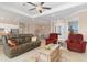 Open living room with tile flooring flowing into the kitchen and dining area at 14556 Gaspar Loop, Port Charlotte, FL 33981