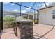 Outdoor kitchen featuring a built-in grill and stone counter, ideal for outdoor cooking at 14556 Gaspar Loop, Port Charlotte, FL 33981