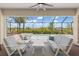Outdoor patio features a seating area, ceiling fan, and a view of the screened pool at 14556 Gaspar Loop, Port Charlotte, FL 33981