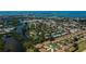 Aerial view of community with mature trees, lake and manicured lawns at 148 Jose Gaspar Dr # 148, Englewood, FL 34223