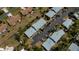 Birds eye view of homes with gray roofs, mature trees and well manicured lawns at 148 Jose Gaspar Dr # 148, Englewood, FL 34223