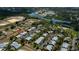 Aerial view of community with mature trees, lake and manicured lawns at 148 Jose Gaspar Dr # 148, Englewood, FL 34223