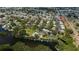 Overhead view of a community featuring a pool, lake access, and docks for boating, surrounded by lush landscaping at 148 Jose Gaspar Dr # 148, Englewood, FL 34223