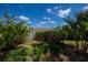 Lush backyard with beautiful landscaping, trees, and flowering bushes at 148 Jose Gaspar Dr # 148, Englewood, FL 34223