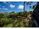 Well manicured backyard with lush green landscaping, including flowering plants at 148 Jose Gaspar Dr # 148, Englewood, FL 34223