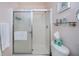 Bathroom showcasing a shower with glass doors, toilet, and a starfish decoration adding a coastal vibe at 148 Jose Gaspar Dr # 148, Englewood, FL 34223
