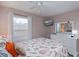 Comfortable bedroom with neutral walls, ceiling fan, and queen bed with decorative seashell pattern at 148 Jose Gaspar Dr # 148, Englewood, FL 34223
