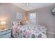 Bedroom featuring a bed with sea-themed patterned bedding, complemented by a bedside table and natural light at 148 Jose Gaspar Dr # 148, Englewood, FL 34223