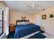 Bedroom with a wicker headboard, ceiling fan, ample natural light, and an accent rug on the floor at 148 Jose Gaspar Dr # 148, Englewood, FL 34223