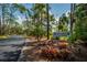 Community sign surrounded by lush greenery and mature trees in a well-maintained neighborhood at 148 Jose Gaspar Dr # 148, Englewood, FL 34223
