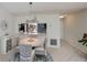 Dining area with pendant lighting, an open view to the kitchen, and neutral decor at 148 Jose Gaspar Dr # 148, Englewood, FL 34223