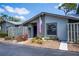 Charming home featuring a cozy entrance with an American flag and colorful landscaping at 148 Jose Gaspar Dr # 148, Englewood, FL 34223