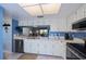 Bright kitchen with white cabinets, modern appliances and a pass-through to the living area at 148 Jose Gaspar Dr # 148, Englewood, FL 34223