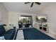 Bright living room features a ceiling fan, TV, comfortable seating, and screened lanai access at 148 Jose Gaspar Dr # 148, Englewood, FL 34223