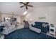 Living room with vaulted ceiling, comfortable seating, and view into dining area at 148 Jose Gaspar Dr # 148, Englewood, FL 34223