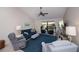Bright living room features a ceiling fan, TV, comfortable seating, and screened lanai access at 148 Jose Gaspar Dr # 148, Englewood, FL 34223