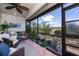 Relaxing screened patio with wicker furniture, plants, and view of well-maintained backyard at 148 Jose Gaspar Dr # 148, Englewood, FL 34223
