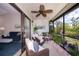 Relaxing screened patio with comfortable wicker furniture and view of the back yard at 148 Jose Gaspar Dr # 148, Englewood, FL 34223