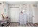 Bedroom with decorative wall paneling, a white dresser, and wood-look floors at 1531 Placida Rd # 201, Englewood, FL 34223