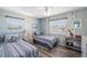 Nautical themed bedroom with two twin beds, wood-look flooring, and ample natural light at 1531 Placida Rd # 201, Englewood, FL 34223