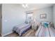 Twin beds with nautical decor, wood-look flooring, and a serene, well-lit atmosphere at 1531 Placida Rd # 201, Englewood, FL 34223