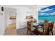 Dining area with coastal decor and adjacent kitchen provides an inviting atmosphere at 1531 Placida Rd # 201, Englewood, FL 34223