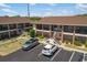 Exterior shot of multi-unit buildings with parking and landscaped areas at 1531 Placida Rd # 201, Englewood, FL 34223