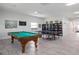 Bright game room at Palm Manor, featuring a pool table, ping pong and bookshelves at 1531 Placida Rd # 201, Englewood, FL 34223