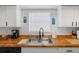 Bright kitchen features white cabinets and butcher block counters and modern appliances at 1531 Placida Rd # 201, Englewood, FL 34223