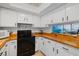 Bright kitchen features white cabinets and butcher block counters and modern appliances at 1531 Placida Rd # 201, Englewood, FL 34223
