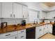 Bright kitchen features white cabinets, butcher block counters, and stainless steel appliances at 1531 Placida Rd # 201, Englewood, FL 34223